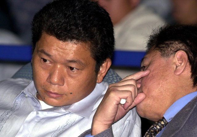 SENATE PROBE. Chinese businessman Kim Wong listens to his lawyer during the 2001 Senate hearing on alleged criminal activities of policemen. Photo from AFP 