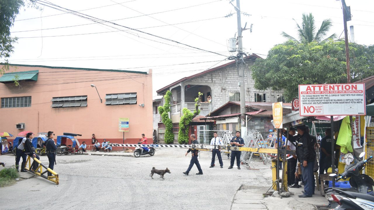 GUARDED. Police (not in photo) and security personnel man the entrance of NutriAsia factory in Marilao. 