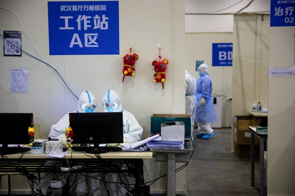 China reports 52 more virus deaths, lowest in 3 weeks