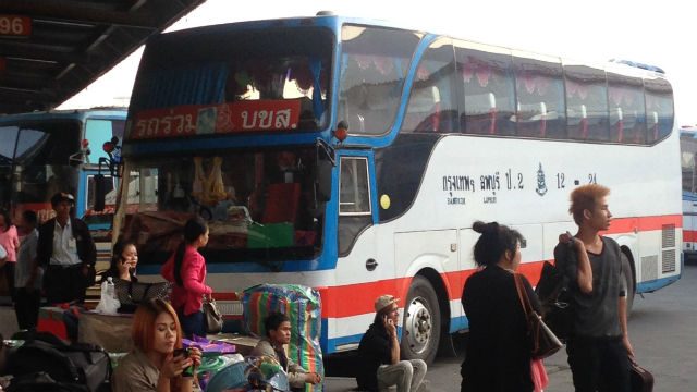 LAND TRAVEL. A Vientiane-bound sleeper bus in Bangkok's Mo Chit Station. 