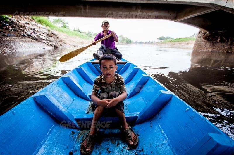 Abah Dayat, dan Fazril, cucunya. Abah Dayat dulu berprofesi sebagai nelayan, kemudian ia kini menjadi pemulung. Foto oleh Greenpeace.  
