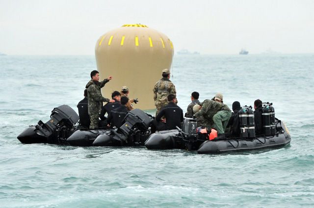 Korea ferry captain arrested, divers spot bodies