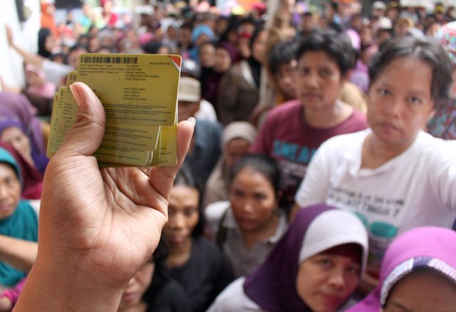 WELFARE CARDS. Residents wait their turn to get new social protection cards at a post office in Depok, Indonesia, on November 25, 2014.  Photo by Adi Weda/EPA 