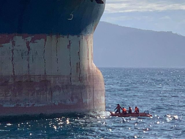 INSPECTION. Philippine Coast Guard personnel examine the damaged stem of Hong Kong bulk carrier Vienna Wood. Photo from the Philippine Coast Guard  