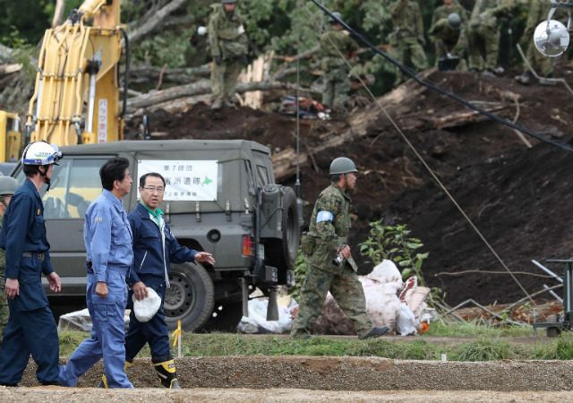 Japan PM Abe visits quake-hit Hokkaido as toll rises to 42