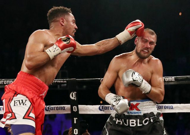 Ward stuns Kovalev in eighth to defend titles