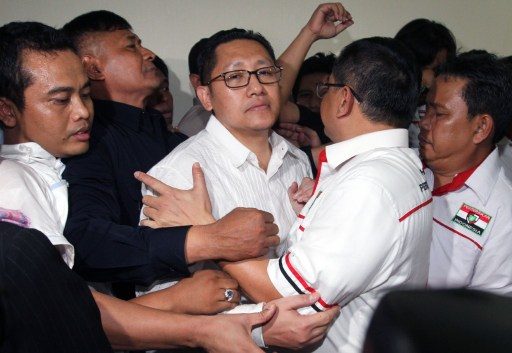 GUILTY. Former head of the Democrat Party Anas Urbaningrum (C) is hugged by his supporters after his guilty verdict was announced in Jakarta on September 24, 2014. Photo by AFP