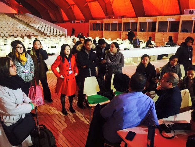 FIGHTING FOR PH. Members of the Philippine delegation huddle inside a plenary hall at the UN climate summit in Paris. Photo from Tony La Viña 