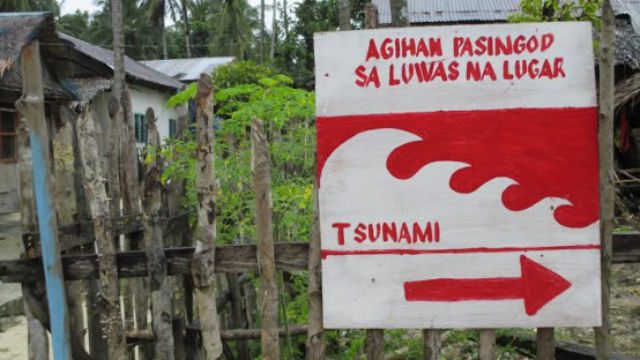 COMMUNITY WARNING. The red-and-white signage directing people where to go in the event of a tidal wave posted on a picket fence in Brgy. Caub 