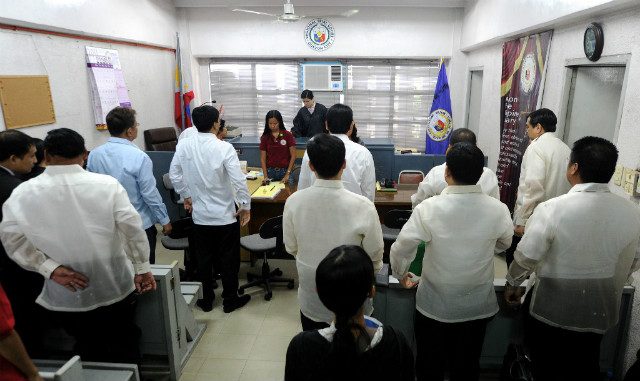 BRANCH 221. Prosecutors and defense lawyers stand up as Judge Jocelyn Solis Reyes (C), who is presiding over the trial of the country's worst political massacre, enters the court room in Quezon City on June 15, 2011. File photo by Noel Celis/AFP  