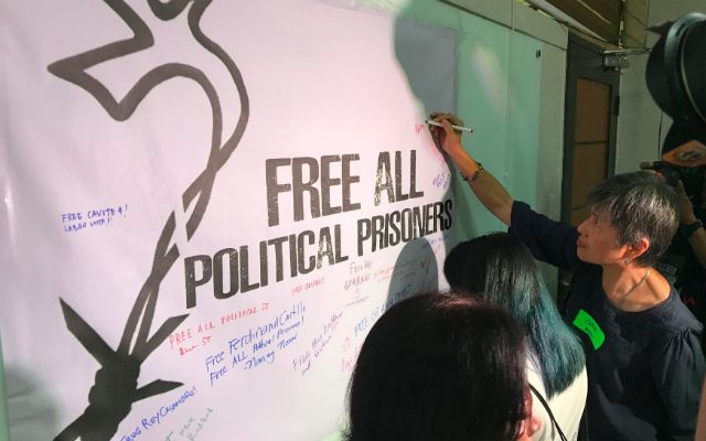 SUPPORT. Advocates sign to show support for political prisoners. 