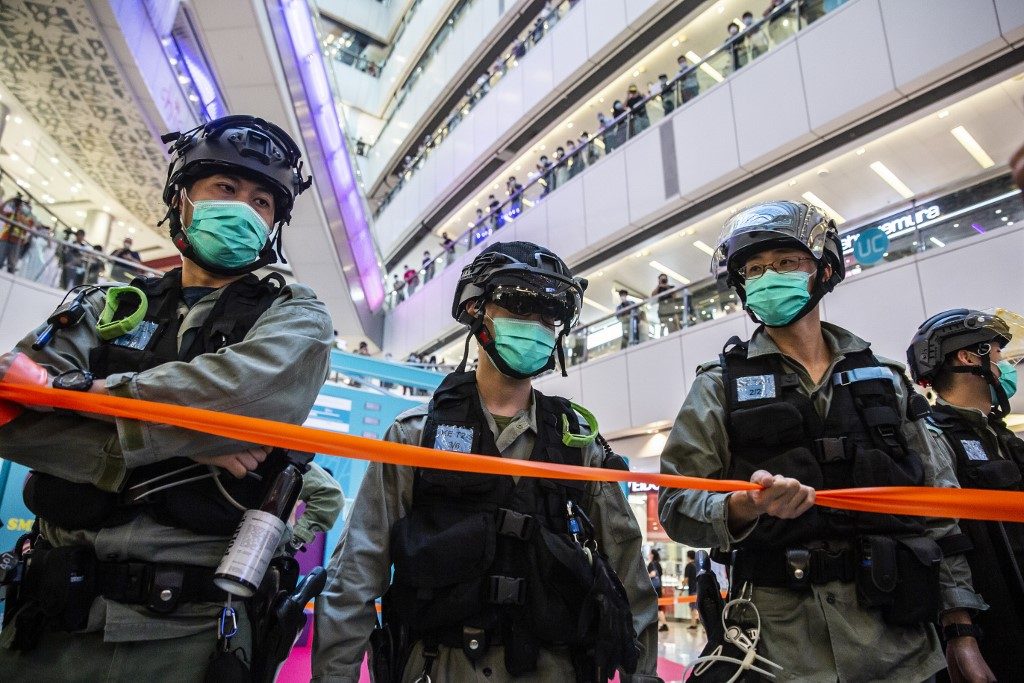HONG KONG. Riot police stand guard during a clearance operation during a demonstration in a mall in Hong Kong on July 6, 2020, in response to a new national security law introduced in the city which makes political views, slogans and signs advocating Hong Kongâs independence or liberation illegal. Photo by Isaac Lawrence/AFP 