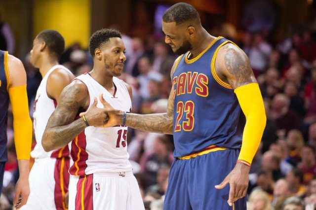 Mario Chalmers #15 of the Miami Heat and LeBron James #23 of the Cleveland Cavaliers shake hands during a game on April 2, 2015. Chalmers is reportedly going to work out with Cleveland. Jason Miller/Getty Images/AFP  