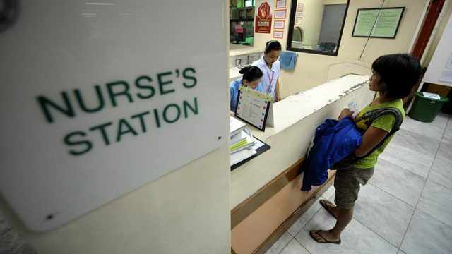 PUBLIC HEALTH. Nurses tend to a woman at the Jose Reyes Memorial Medical Center in Manila. File photo by AFP  