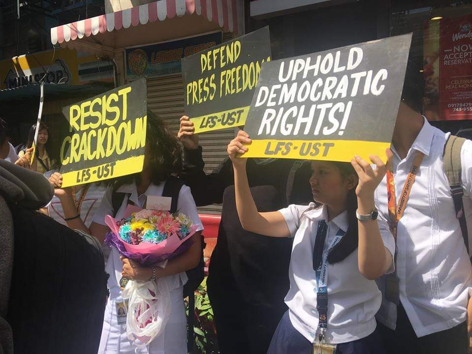 FREEDOM. Students carry signs that urge people to defend press freedom in a protest action at UST Gate 11, Dapitan on February 14, 2019. Photo from League of Filipino Students UST  