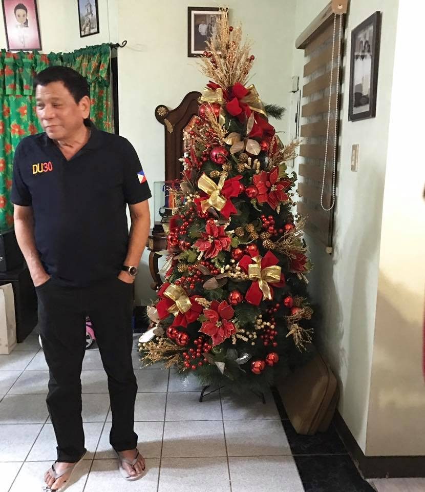 SIMPLE. President Duterte stands beside their family Christmas tree. Photo courtesy of Rep Lord Allan Velasco  
