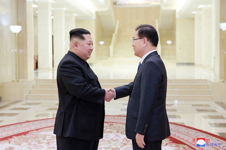SHAKING HANDS. North Korean leader Kim Jong-Un (L) shakes hands with South Korean chief delegator Chung Eui-yong (R), who travelled as envoys of the South's President Moon Jae-in, during their meeting in Pyongyang on March 5, 2018. Photo by KCNA via KNS/AFP 