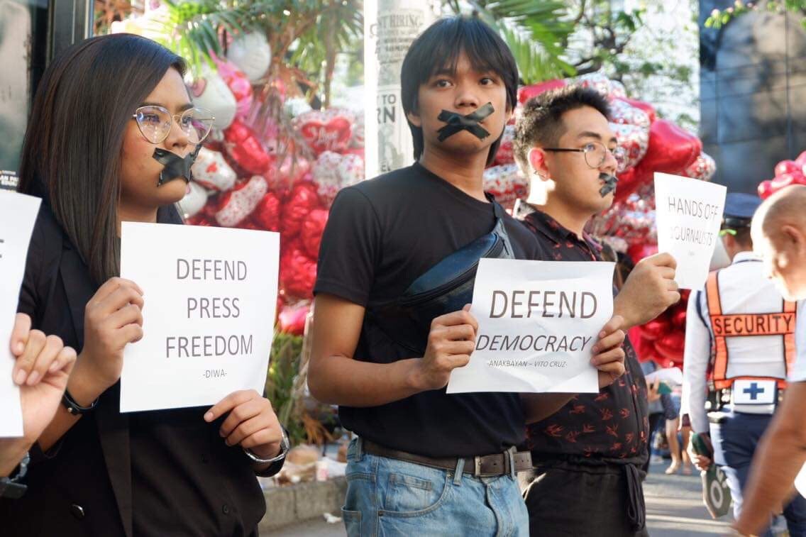DEFEND DEMOCRACY. Progressive youth groups cover their mouths with black tape to highlight the importance of defending press freedom during a protest action along the Taft Vito Cruz area on February 14, 2019. Photo by Anakbayan Vito Cruz  