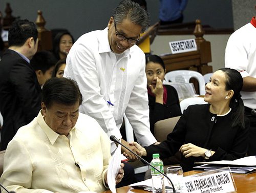 Mar Roxas and Senator Grace Poe, both vying the presidency, share a light moment. Senate file photo  