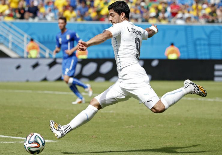 Uruguay’s Luis Suarez fires a shot on target against Italy during the World Cup. Photo by Kamil Krzaczynski/EPA