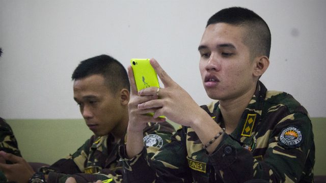 MOBILE TECHNOLOGY. An ROTC officer in Iloilo uses a smartphone to tweet critical information for disasters. Photo by Vina Salazar/ Rappler 