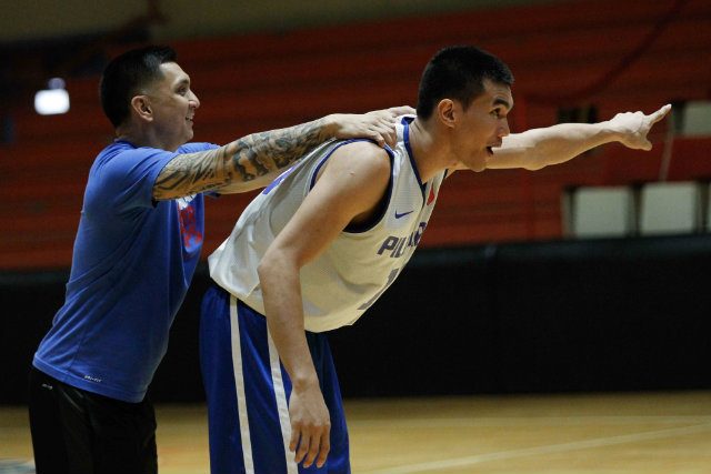 Sinag Pilipinas assistant coach Jimmy Alapag gives National University's Troy Rosario a shoulder rub as he calls out plays during the cadets practice for the SEA Games. File Photo by Czeasar Dancel/Rappler 