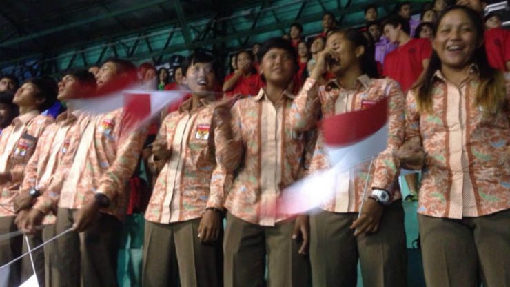NATIONAL PRIDE. Indonesians young athletes wave their flag as their national anthem is being sung. 