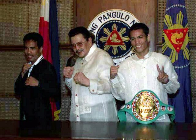 CHAMPS. Malcolm Tunacao (right), seen with then-Philippine president Joseph Estrada and WBA strawweight titleholder Joma Gamboa, shows off his WBC flyweight title during a 2000 visit to Malacanang Palace. Photo by AFP   