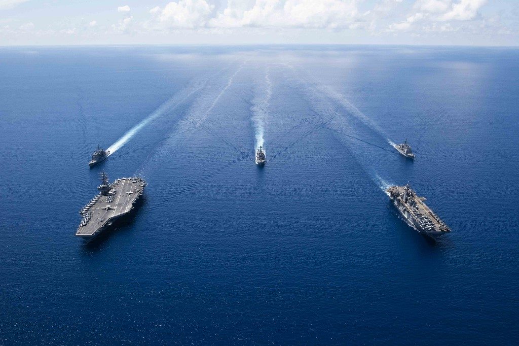 DRILLS. This US Navy photo obtained October 7, 2019 shows the aircraft carrier USS Ronald Reagan (left), and the amphibious assault ship USS Boxer and ships from the Ronald Reagan Carrier Strike Group and the Boxer Amphibious Ready Group conducting operations in the US 7th Fleet area of operations in the South China Sea. File photo Navy Office of Information/AFP  