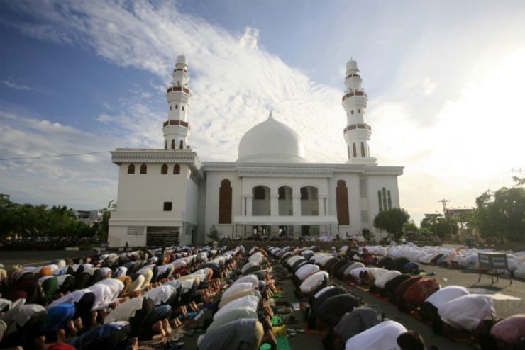 Muslims performing morning prayers outside a mosque in Banda Aceh, Indonesia, on Idul Fitri. Photo by EPA