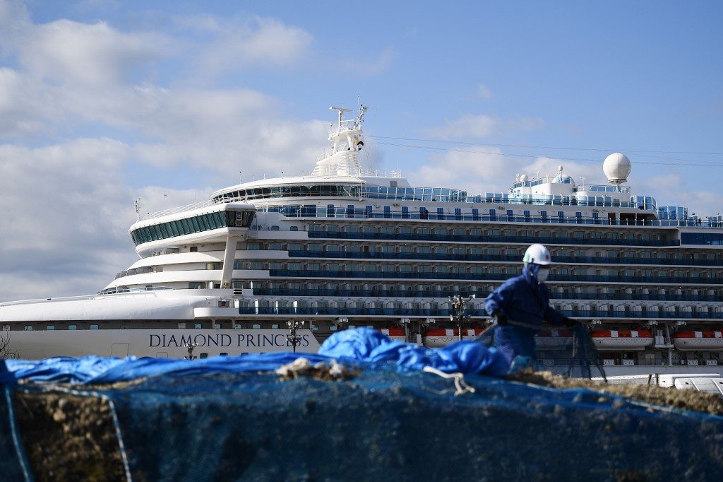 QUARANTINED. A worker is seen against the Diamond Princess cruise ship in quarantine due to fears of the new COVID-19 coronavirus, at the Daikoku Pier Cruise Terminal in Yokohama on February 19, 2020. Photo by Charly Triballeau/AFP 