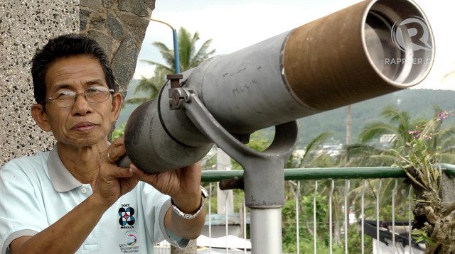 OBSERVER. Mayon resident volcanologist Ed Laguerta looks at Mayon Volcano through an American colonial period telescope also used during the 1991 Pinatubo eruption