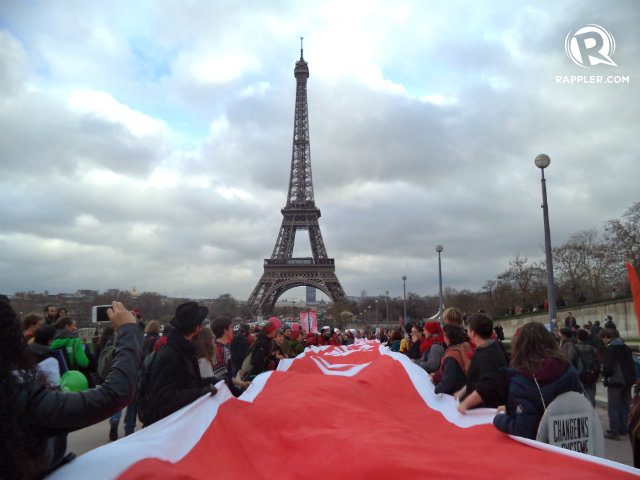 RED LINES. Advocates carry a long trail of red cloth to represent 'red lines' or climate issues that cannot be compromised 