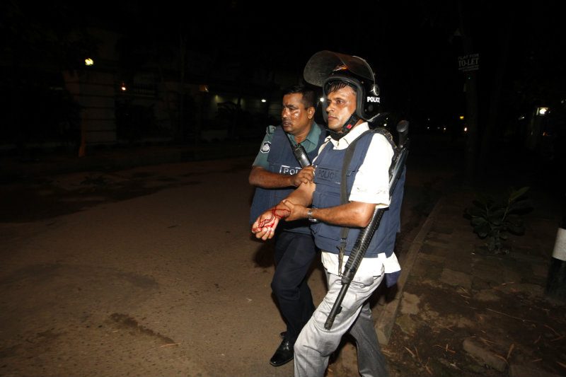 HOSTAGE SIEGE. An injured police officer is escorted by a colleague after suffering wounds from a crude bomb blasted by suspected criminals at a Spanish resturant in Dhaka, Bangladesh, late 01 July 2016. Two police officials have been killed during the encounter while some gunmen reportedly took several people hostage, including some foreigners, inside a Spanish resturant. Photo by EPA 
