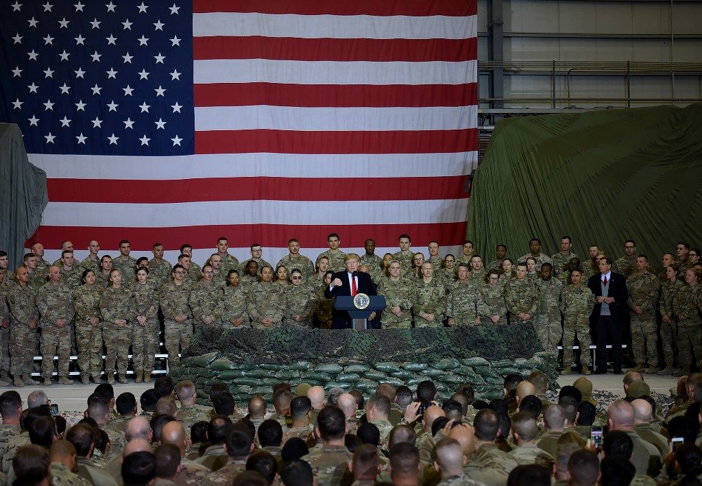 Trump visits troops in Afghanistan, says Taliban talks back on