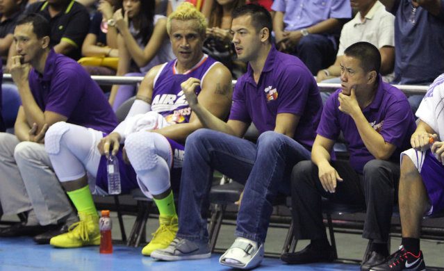 Sean Anthony sits in street clothes next to Asi Taulava during Game 3 of the San Mig Coffee series. Photo by Nuki Sabio/PBA Images