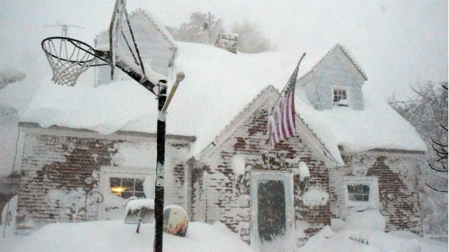 KNEE DEEP. A home in Buffalo New York is blanketed in snow. Photo by Mark Webster/EPA 
