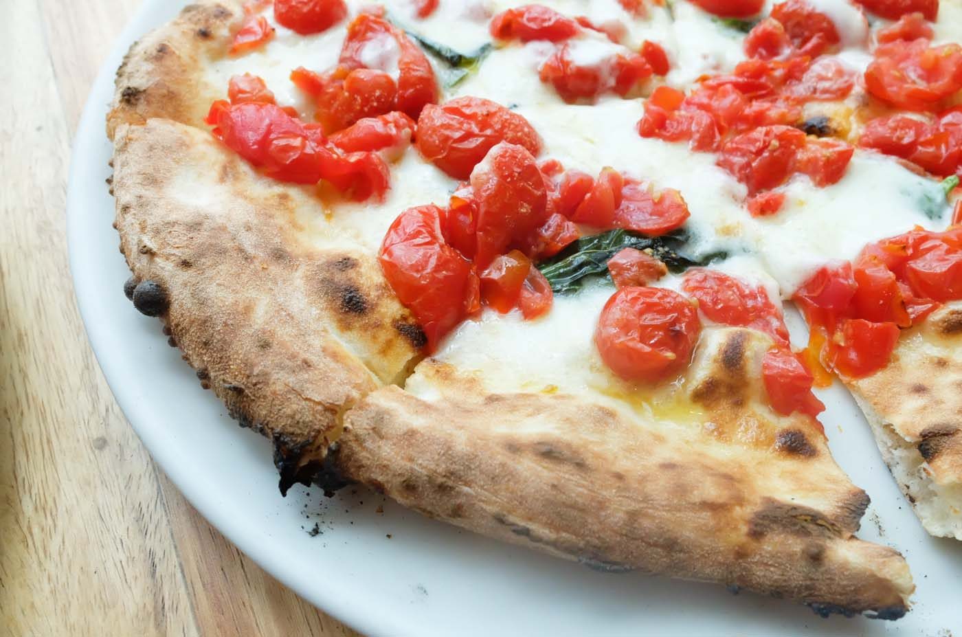 MEET THE DOC. This award-winning pizza is topped with fresh cherry tomatoes imported from Japan  