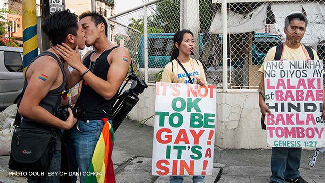 LOVE. Anti-LGBT protestors, next to a pair of lovers, join the annual Pride March. Photo from Dani Ochoa   