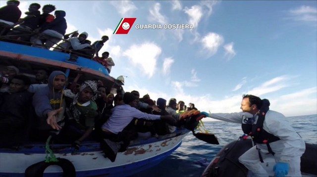 SEA RESCUE. In this video grab released by the Italian Coast Guards (Guardia Costiera) on April 13, 2015 a boat of the Italian Guardia Costiera takes part in a rescue operation of migrants off the coast of Sicily on April 12, 2015. Guardia Costiera/AFP 