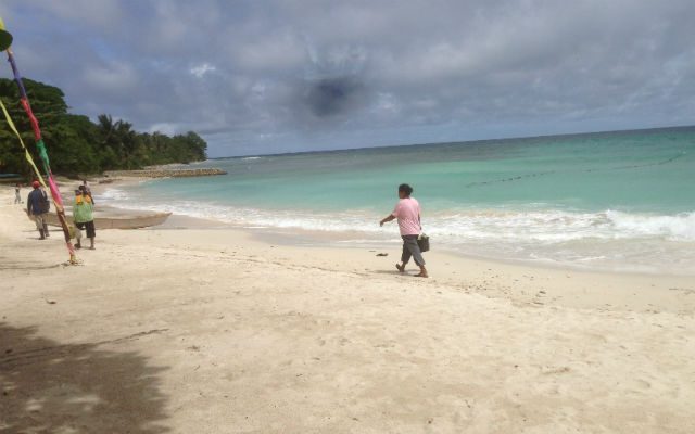 A local walks around White Beach in Malamawi Island. 