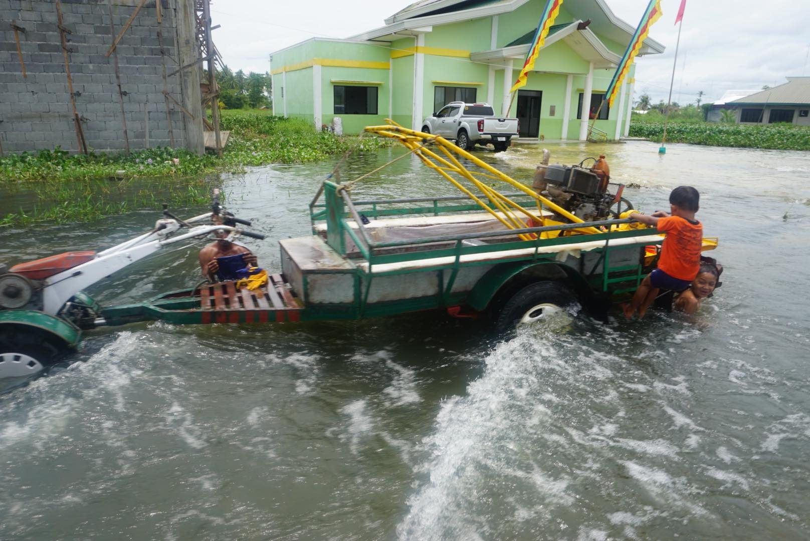 KULIGLIG. The kuliglig, a hand tractor attached with a small trailer,  help people get around the flooded evacuation site in Barangay Pagatin. Photo from Oxfam in the Philippines 