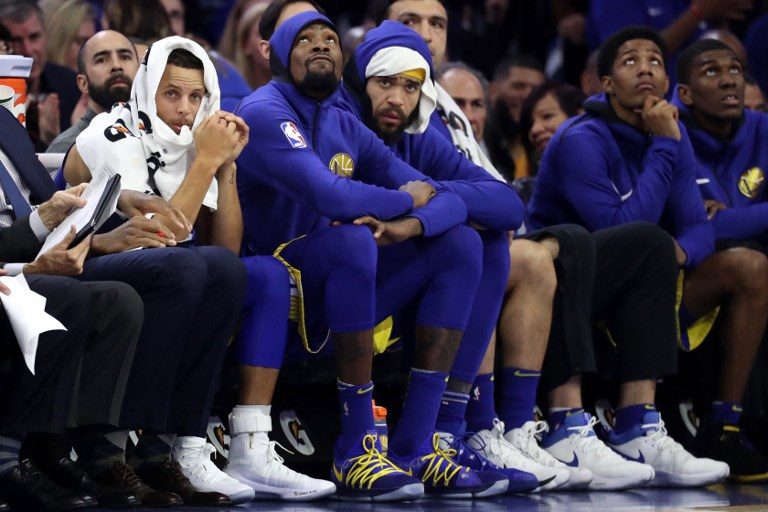 BENCHED. In this file photo, Stephen Curry #30 (left), Kevin Durant #35 (center), and JaVale McGee #1 of the Golden State Warriors look on from the bench. Photo by Rob Carr/Getty Images/AFP 