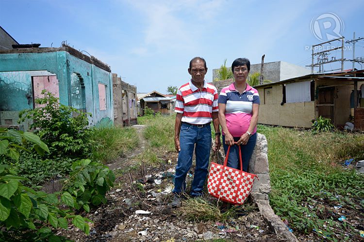 The Delgados standing where their house used to be. Photo by LeAnne Jazul/Rappler