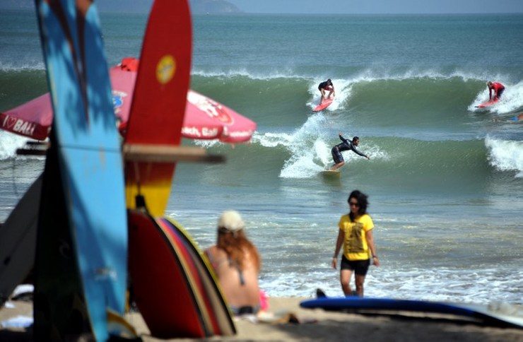 KUTA BEACH. Surfers ride waves at Kuta beach on Bali island. File photo by AFP 