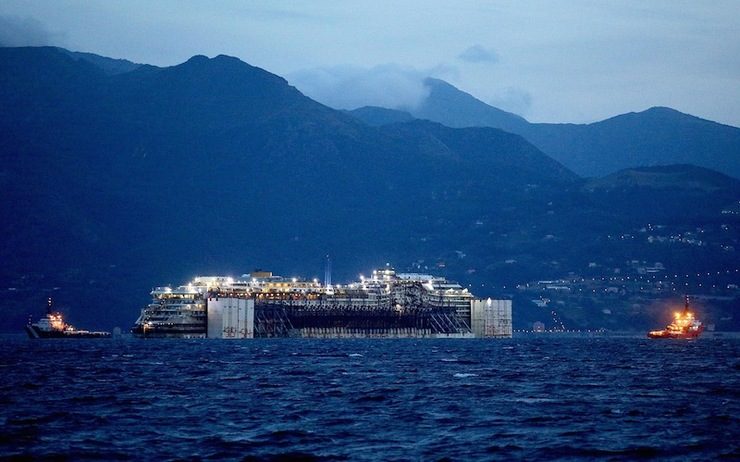 PORT OF CALL. Italian cruise liner Costa Concordia in front of Genoa's port, Italy, 27 July 2014. The Costa Concordia has arrived in Genoa, where dismantling operations are predicted to last two years. Alessandro Di Meo/EPA