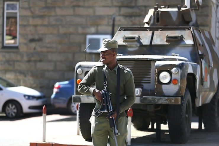 LOOKOUT. A member of the Lesotho military stands guard alongside an military vehicle in Maseru, Lesotho, 31 August 2014. Stringer/EPA