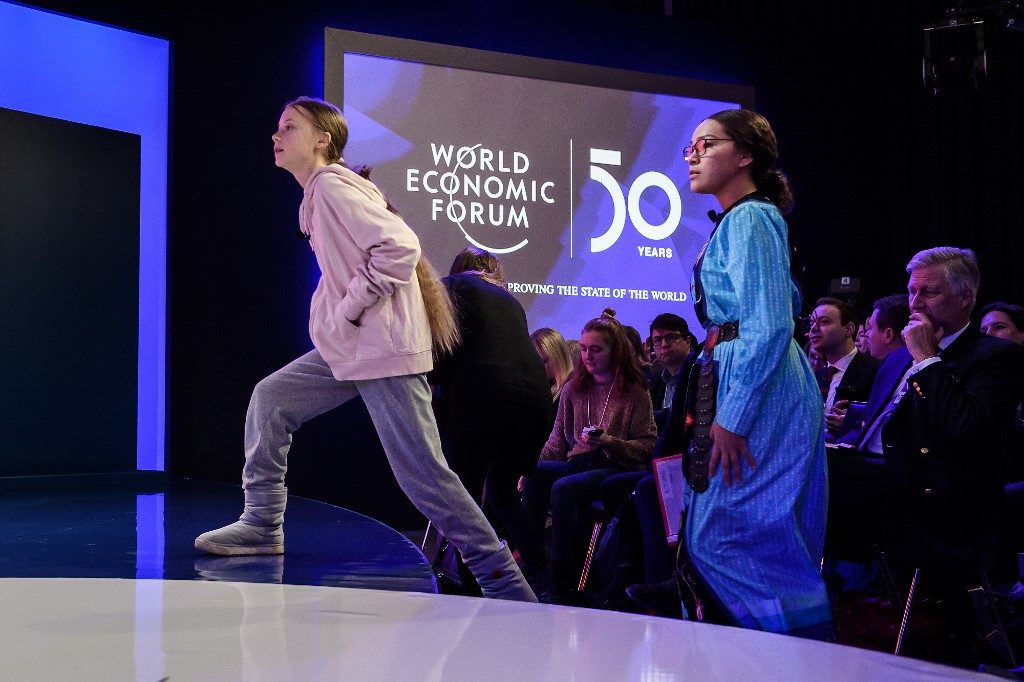 YOUTH VOICE. Swedish climate activist Greta Thunberg (lef), followed by Canadian climate and environmental activist Autumn Peltier, arrives to the Congres center during the World Economic Forum (WEF) annual meeting in Davos, on January 21, 2020. Photo by Fabrice Cofffrini/AFP  
