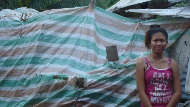 SHELTER. In the outskirts of the town proper, Angelie Trayco, 18, is busy fixing their wet things in their ruined house after Typhoon Ruby threatened to wreak havoc on their town.
