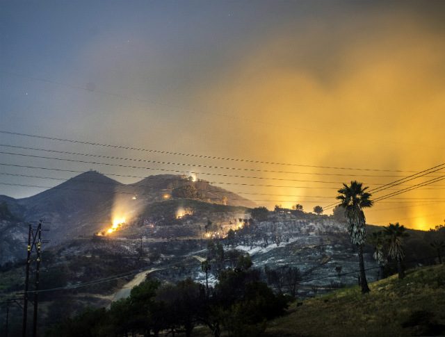 Man charged with arson amid raging California fires